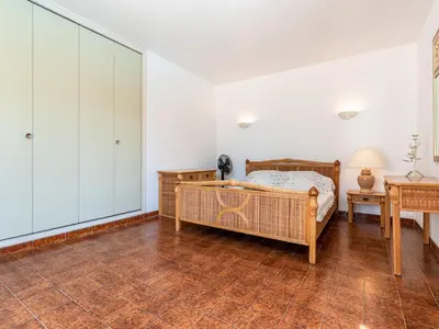 a bedroom with a bed and a table at Holiday Home Casella by Interhome in Prunelli-di-Fiumorbo