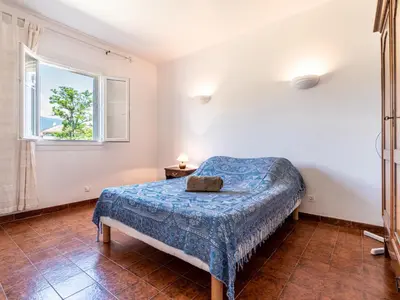a bedroom with a bed and a window at Holiday Home Casella by Interhome in Prunelli-di-Fiumorbo