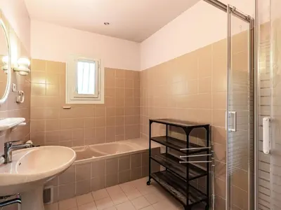 a bathroom with a tub and a sink and a shower at Holiday Home Casella by Interhome in Prunelli-di-Fiumorbo