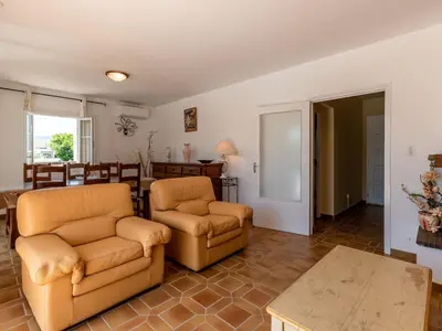 a living room with two chairs and a table at Holiday Home Casella by Interhome in Prunelli-di-Fiumorbo