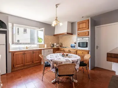 a kitchen with a table and chairs in a kitchen at Holiday Home Casella by Interhome in Prunelli-di-Fiumorbo