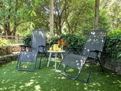 three chairs and a table in a yard at Holiday Home Svyntha by Interhome in Prunelli-di-Fiumorbo