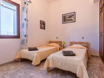 two beds in a room with a window at Apartment Casa Antoinette by Interhome in Prunelli-di-Fiumorbo