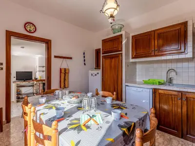 a kitchen with a table with a table cloth on it at Apartment Casa Antoinette by Interhome in Prunelli-di-Fiumorbo