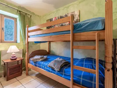 a bedroom with two bunk beds in a room at Holiday Home Migone de Sampolo by Interhome in Ghisoni