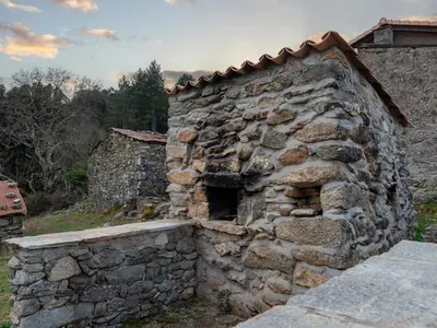 an old stone building with a stone wall at Holiday Home Migone de Sampolo by Interhome in Ghisoni