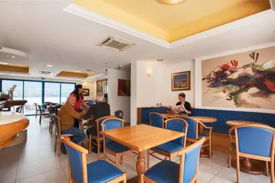 a restaurant with people sitting at tables at Le Neptune & Spa in Propriano