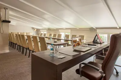a conference room with a long table and chairs at Le Neptune & Spa in Propriano