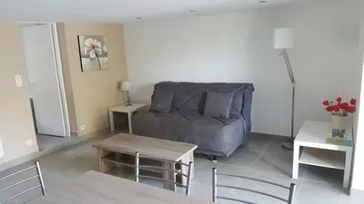 a living room with a couch and a table at Rez de Villa in Loreto-di-Tallano