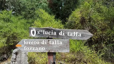 a street sign in front of some trees at Rez de Villa in Loreto-di-Tallano