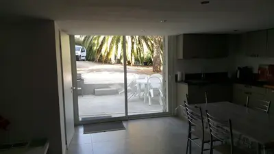 a kitchen with a sliding glass door to a patio at Rez de Villa in Loreto-di-Tallano