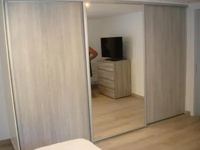a sliding glass door leading to a bedroom with a television at Rez de Villa in Loreto-di-Tallano