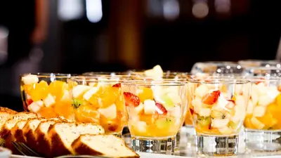 a table topped with glasses filled with fruit and bread at Rossi Hôtel in Sartène