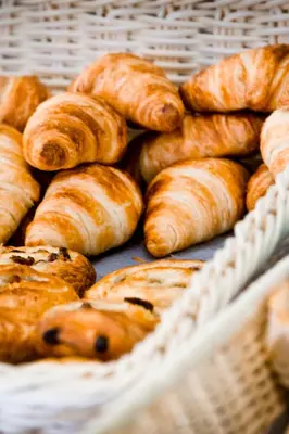 a basket filled with lots of different types of bread at Rossi Hôtel in Sartène