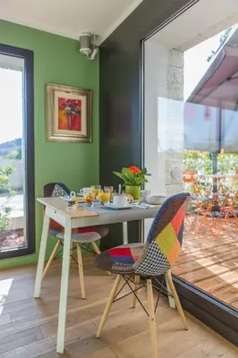 a dining room with a table and two chairs at Rossi Hôtel in Sartène