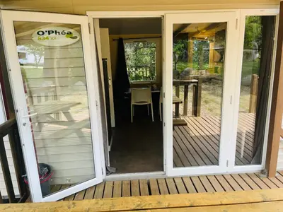 a sliding glass door on a porch with a table at Les Bergeries de Petralonga in Sotta