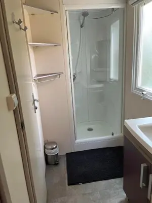 a bathroom with a shower and a glass shower backdoor at Les Bergeries de Petralonga in Sotta