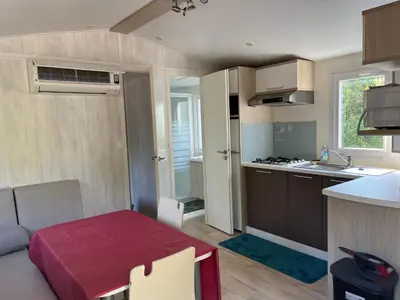 a small kitchen with a red table in a room at Les Bergeries de Petralonga in Sotta