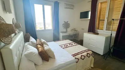 a bedroom with a bed and a window at Hôtel Les 3 Terrasses in Sari Solenzara
