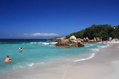 a group of people swimming in the ocean on a beach at Casa Nelly in Porticcio