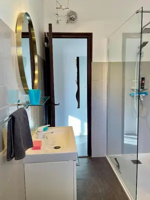a bathroom with a sink and a shower at Casa Nelly in Porticcio