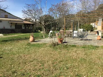 a yard with a patio with a table and chairs at Ernella in Aléria