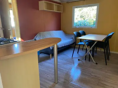 a room with a bed and a table and chairs at Ernella in Aléria