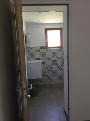 a bathroom with a toilet and a window at Ernella in Aléria