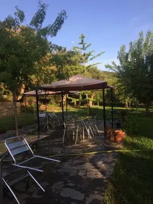 a group of tables and chairs under a gazebo at Ernella in Aléria