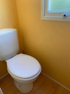 a white toilet in a bathroom with a window at Ernella in Aléria