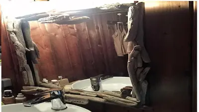 a bathroom with a sink and a mirror at Tente Lodge Bord de Mer in Coti-Chiavari