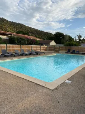 a large swimming pool with lounge chairs around it at Marina Di Fautea in Olmucciu