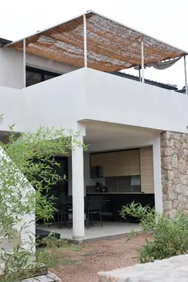 an external view of a white house with a kitchen at Marina Di Fautea in Olmucciu