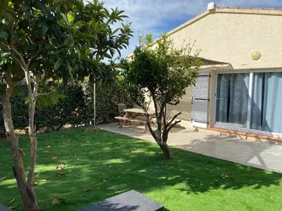 a garden with a table and trees in a yard at Marina Di Fautea in Olmucciu