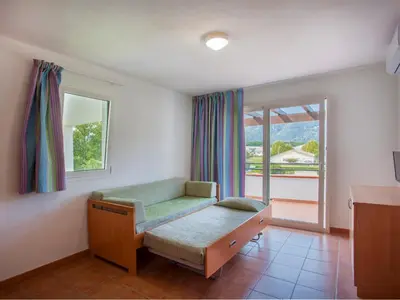 a hospital room with a bed and a window at Vacancéole - Résidence Sognu di Rena in San-Nicolao