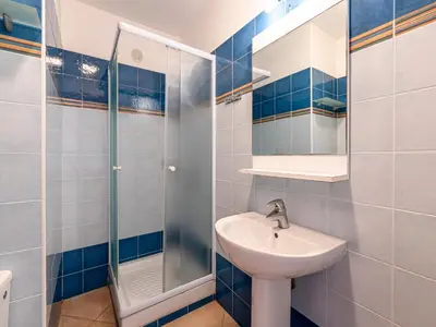 a bathroom with a sink and a shower at Vacancéole - Résidence Sognu di Rena in San-Nicolao