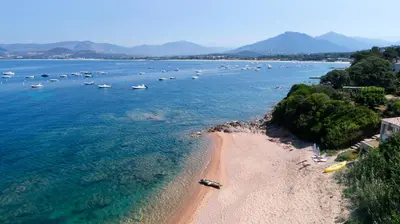 an aerial view of a beach with boats in the water at Villas les Residences de Scaglione in Porticcio