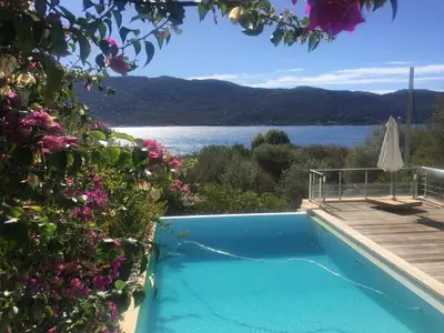 a swimming pool with a view of the water at Casaluce in Casaglione