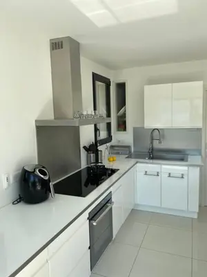 a white kitchen with white cabinets and a sink at Casaluce in Casaglione