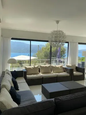 a living room with couches and a large window at Casaluce in Casaglione