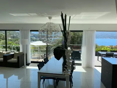 a living room with a table and a view of the ocean at Casaluce in Casaglione