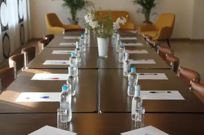 a row of tables with bottles of water on them at Hotel Maquis et Mer in Sari Solenzara