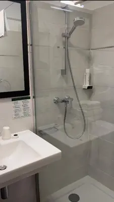 a bathroom with a shower and a sink at Hotel Maquis et Mer in Sari Solenzara