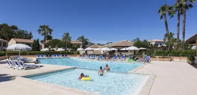 a group of people in a swimming pool at a resort at Vacancéole - Résidence Sognu di Mare in Linguizzetta