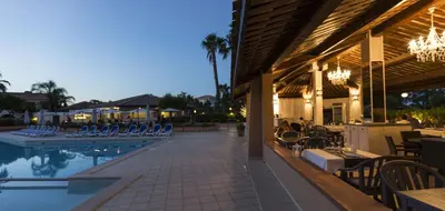 a resort with a pool and chairs and a restaurant at Vacancéole - Résidence Sognu di Mare in Linguizzetta