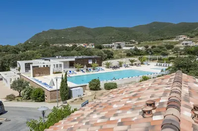 a view of the pool from the roof of a hotel at Résidence Odalys Les Villas de Bel Godère in Belgodère