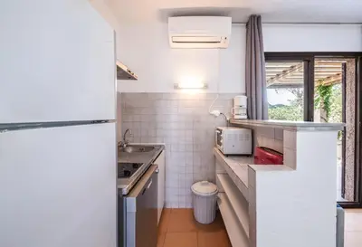 a small kitchen with a sink and a counter at Sapa Di Cala in Bonifacio