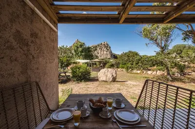 a wooden table with food and drinks on it at Sapa Di Cala in Bonifacio
