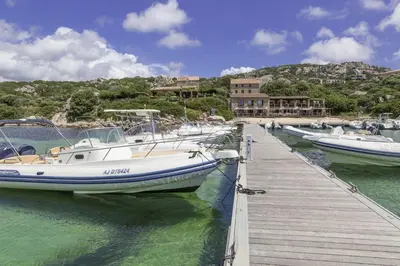 a group of boats docked at a dock in the water at Résidence Odalys Stella di l'Aria in Tizzano