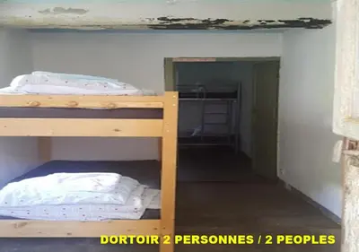 two bunk beds in a small room with a closet at Auberge de Jeunesse Chez Mc Donald in Zevaco